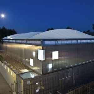 night image of the exterior of the sports center cover